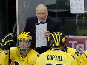 In this March 20, 2014, file photo, Michigan head coach Red Berenson, top, talks with players during a game against Penn State, in St. Paul, Minn. B (AP Photo/Ann Heisenfelt, FIle)