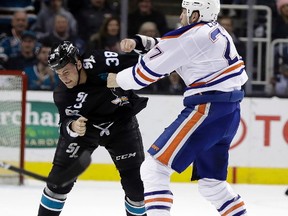 San Jose Sharks' Micheal Haley (38) fights with Edmonton Oilers' Milan Lucic during the first period of an NHL hockey game Thursday, April 6, 2017, in San Jose, Calif.