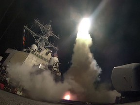 In this image provided by the U.S. Navy, the guided-missile destroyer USS Porter (DDG 78) launches a missile in the Mediterranean Sea on Friday, April 7, 2017. (Mass Communication Specialist 3rd Class Ford Williams/U.S. Navy via AP)