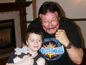 Former WWE great Ted DiBiase — The Million Dollar Man — meets seven-year-old Trenton wrestling fan Justin Maloney during his comedy show Monday night at The Banquet Centre. (Paul Svoboda/The Intelligencer)