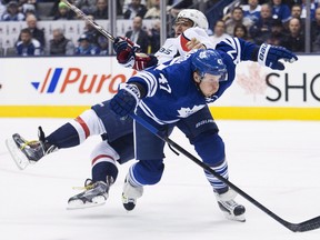 Maple Leafs forward Leo Komarov (47) trips up Capitals forward Alex Ovechkin Wednesday, January 7, 2015 in Toronto. (THE CANADIAN PRESS/Nathan Denette)