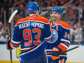 Jordan Eberle (14) of the Edmonton Oilers, celebrates his hat-trick goal with Ryan Nugent-Hopkins (93) against the Vancouver Canucks at Rogers Place in Edmonton on April 9  2017.