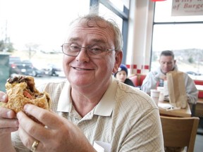 Barry Stenabaugh enjoys a hamburger at Five Guys Burgers and Fries in Sudbury, Ont. on Monday April 10, 2017. The restaurant opened for business on Monday. Gino Donato/Sudbury Star/Postmedia Network