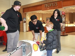 Northern Collegiate Eco-Team members Robert Boccanfuso, Afnan Shaikh and faculty adviser Nayi Rincon talk to five year-old car enthusiast Keaton about the Rover, Northern Eco-Team's entry to the upcoming Shell Eco Marathon Americas competition, which takes place in Detroit from Apr. 27th to Apr. 30th. 
CARL HNATYSHYN/SARNIA THIS WEEK