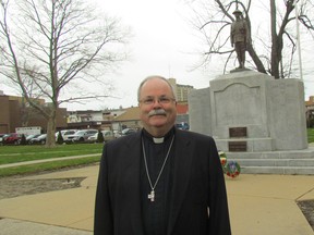 Rev. Canon Vicars Hodge, from Trinity Anglican Church in Sarnia, stands Tuesday at the cenotaph in Sarnia. He's named for a soldier who pulled his injured grandfather from the muddy battlefield at Vimy Ridge, 100 years ago. (Paul Morden/Sarnia Observer/Postmedia Network)