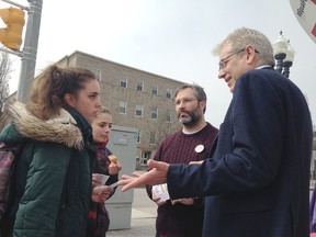 Federal NDP leadership candidate Charlie Angus, right, and professor Jordan Morelli, speak with Queen's University music students Danella Ahlberg, left, and Greta Racco about gender pay equity at a rally in Kingston, Ont. on Tuesday, April 11, 2017. 
Elliot Ferguson/The Whig-Standard/Postmedia Network