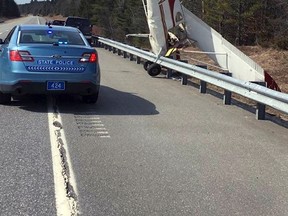 In this photo released by Maine State Police, a plane stands on its nose after striking a guardrail after it landed Tuesday, April 11, 2017, in the southbound lane of Interstate 295 in Bowdoinham, Maine. (Maine State Police via AP)