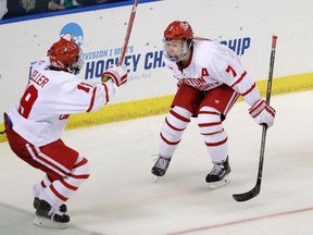 Boston University defenceman Charlie McAvoy skates to forward Clayton Keller after scoring during the second overtime of an NCAA West Regional college hockey game against North Dakota on March 24, 2017. (AP Photo/Carlos Osorio)