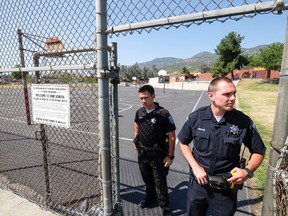 Police officers stand guard outside North Park School after a deadly shooting Monday, April 10, 2017, in San Bernardino, Calif. (AP Photo/Ringo H.W. Chiu)