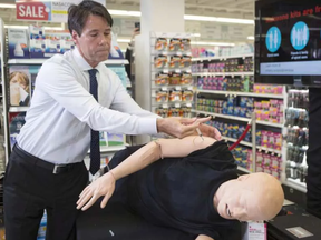 Ontario Health Minister Dr. Eric Hoskins demonstrates how to inject naloxone, taken from a naloxone emergency kit, at a pharmacy in Toronto on Tuesday April 11, 2017. Naloxone is a medication that reverses the effects of an overdose from opioids such as heroin, methadone, fentanyl and morphine. CHRIS YOUNG / THE CANADIAN PRESS