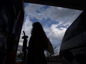Sophia Netterfield fills up on fuel in Toront on Tuesday, April 11, 2017. A six-cent per litre spike was expected on Wednesday. (ERNEST DOROSZUK/TORONTO SUN)