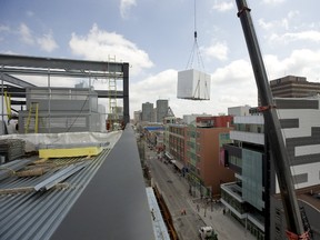 While Fanshawe College officials were welcoming Siemens Canada?s $28-million software donation at the main campus on Oxford Street, crews were busy installing air-handling units at Fanshawe?s new downtown campus in the former Kingsmill?s building. Dundas Street was closed between Richmond and Talbot streets as the heating, ventilating and air conditioning devices were lifted into place. (MIKE HENSEN, The London Free Press)