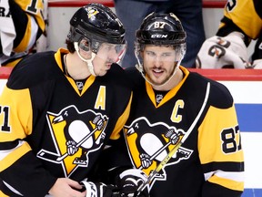In this May 10, 2016, file photo, Pittsburgh Penguins' Sidney Crosby and Evgeni Malkin talk as they return to the ice after a stop in play during Game 6 of the Eastern Conference semifinals against the Washington Capitals in Pittsburgh. (AP Photo/Gene J. Puskar, File)