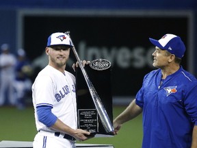 Josh Donaldson is presented with the Silver Slugger Award by John Gibbons before the Blue Jays face the Milwaukee Brewers in its home season opener in Toronto on April 11, 2017. (Michael Peake/Toronto Sun/Postmedia Network)