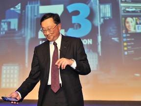 John Chen, right, Chief Executive Officer BlackBerry, holds the newly launched BlackBerry Z3 smartphone 'Jakarta edition' during a ceremony in Jakarta on May 13, 2014. (ADEK BERRY/AFP/Getty Images)