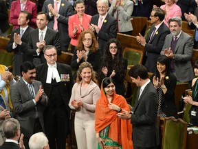 Prime Minister Justin Trudeau, right, and his wife Sophie Gregoire Trudeau, centre left, clap as Pakistani activist and Nobel Peace Prize winner Malala Yousafzai, centre, is paid tribute in the House of Commons on Parliament Hill in Ottawa on Wednesday, April 12, 2017. THE CANADIAN PRESS/Adrian Wyld