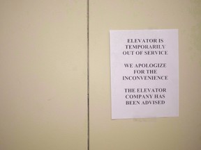 A sign is taped to a door of an elevator in a downtown Toronto office building on July 13, 2016. A private member's bill aims to tackle the problem of unreliable elevators. (THE CANADIAN PRESS/PHOTO)