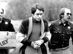 Ted Bundy is led into the Pitkin County courthouse by Deputy Peter Murphy, left, and Rick Kralicek for a hearing in Aspen, Colo., on June 8, 1977. (AP Photo/Mark Levy)