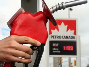 Ottawa resident David Allard watches the dollars rack up as he filled his tank at a Petro-Canada station on Carling Avenue Wednesday (April 12, 2017). JULIE OLIVER / POSTMEDIA