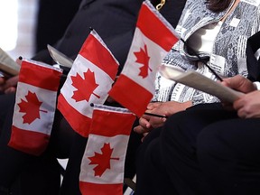 New Canadians look on following a special citizenship ceremony at VIA Rail's Union Station on Main Street in Winnipeg on March 14, 2017. (Kevin King/Postmedia Network)