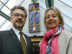 Scott Watson (left) and sister Catherine Watson (right) donated a stain glass window (background) to the Grey Nuns Hospital in southeast Edmonton, where it was unveiled in the front foyer of the hospital on Wednesday April 12, 2017.  (PHOTO BY LARRY WONG/POSTMEDIA)