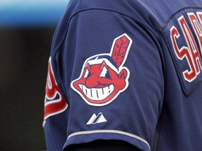 In this April 8, 2014 photo, the Cleveland Indians Chief Wahoo logo is shown on the uniform sleeve of third base coach Mike Sarbaugh during a baseball game against the San Diego Padres in Cleveland, Ohio. (THE CANADIAN PRESS/AP-Mark Duncan)