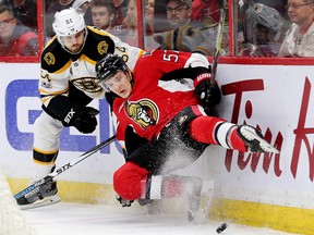 Tommy Wingels is upended by Adam McQuaid in the first period as the Ottawa Senators meet the Boston Bruins at the Canadian Tire Centre in Game 1 on April 12, 2017. (Wayne Cuddington/Postmedia)