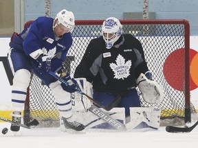 Leafs centre Leo Kormarov tries to get to the puck in front of goalie Curtis McElhinney at practice in Toronto as they prepare 
for Game 1 of the playoffs in Washington tonight. Net presence is likely to be a major factor in the series against the Capitals. (Jack Boland/Toronto Sun)