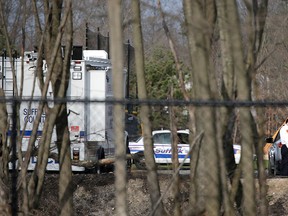 Emergency personnel talk near a crime scene where four bodies were discovered in Central Islip, N.Y., Thursday, April 13, 2017.   (AP Photo/Seth Wenig)