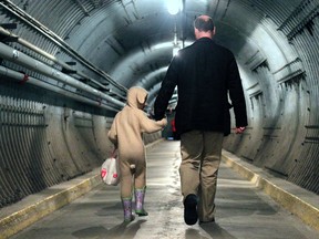 Files: The annual Easter Egg Hunt was held at the Diefenbunker in Carp, Peter St. Jacques walks out of the long tunnel into the facility with his daughter Eliza, 4, happily dressed in her bunny suit with a bag full of chocolate.