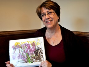 Trish Capitano-Andrew holds watercolour art done by her mom, Kay Capitano, who suffers from Alzheimer’s disease, on March 30, 2017. The art will be displayed in a gallery at The ARTS Project April 18-22 dedicated to people and families affected by Alzheimer’s. CHRIS MONTANINI\LONDONER\POSTMEDIA NETWORK