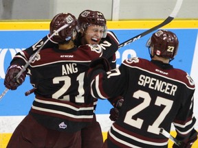 Peterborough Petes' Chris Paquette celebrates his goal with teammates Jonathan Ang and Matt Spencer during Game 2 of an OHL Eastern Conference semifinal series in Peterborough on April 9. The Petes lead the series 3-0 with Game 4 in Kingston Thursday night. (Clifford Skarstedt/Postmedia Network)