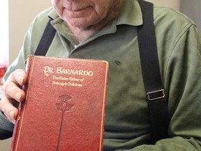 Cyril Hewitt, 93, of Sarnia, holds up a biography of Dr. Thomas Barnardo, the founder of a British charity that took in poor children starting in the 1860s. Hewitt received the book when he and his three brothers were sent to live in a Barnardo's Home near London, England. Hewitt was eventually shipped to Canada at the age of 14 to work as a farm labourer. Barbara Simpson/Sarnia Observer/Postmedia Network