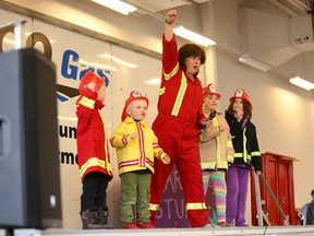 Mary Lambert leads children volunteers on stage in her musical and dance performance during the fifth annual Fire Safety Day at Chinook Winds Fire Station on Oct. 15, 2016, in Airdrie, Alta. (Britton Ledingham/Postmedia Network)