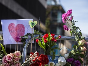 Flowers are left on a fence outside of the Ahlens department store in Stockholm, Sweden on April 9, 2017. An Uzbek man was arrested and held on terrorism charges, following the attack which killed four people and injured another 15 when a hijacked truck crashed into the front of Ahlens department store. (Michael Campanella/Getty Images)