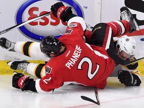 Boston Bruins left winger Brad Marchand and Ottawa Senators defenceman Dion Phaneuf get tangled up during an NHL playoff game on April 12, 2017. (THE CANADIAN PRESS/Sean Kilpatrick)