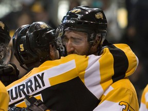 Kingston Frontenacs defenceman Liam Murray embraces an emotional Stephen Desrocher following a series-ending 6-2 loss to the Peterborough Petes in OHL playoff action at the Rogers K-Rock Centre Thursday night. For Desrocher, the Frontenacs captain and an overage player, it was his final OHL game. (Taylor Bertelink/For The Whig-Standard)