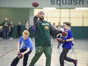 Edmonton Eskimo long snapper Ryan King threw footballs to students during a free football camp at the Eastlink Centre on Tuesday April 11, 2017 while Aspen Grove students William Strilceff (left) and Aidan Sinclair collect balls behind him at the Eastlink Centre in Grande Prairie, Alta. The Eskimos will be holding their mini-camp in Las Vegas this year.
