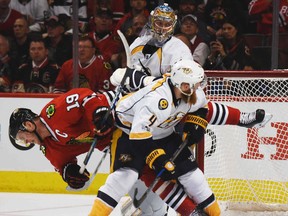 Chicago Blackhawks centre Jonathan Toews falls to the ice after coming into contact with Nashville Predators defenceman Ryan Ellis during Game 1 of a first-round NHL hockey playoff series Thursday, April 13, 2017, in Chicago. (Joe Lewnard/Daily Herald via AP)