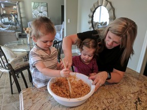 Maggie Elliott and her two children, Eli, aged three, and two-year-old Molly, prepare a family favourite at the County of Lambton Employee Easter bake sale in support of the United Way of Sarnia-Lambton. County municipal employees hold events like the bake sale throughout the year to raise money for the local United Way. Although fundraising has already begun for the 2017 campaign, the United Way of Sarnia-Lambton campaign goal will be announced in August. (Handout)