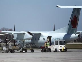 An Air Canada flight from Toronto disembarks its passengers on the tarmac at London airport on Friday. (MIKE HENSEN, The LondoN Free Press)