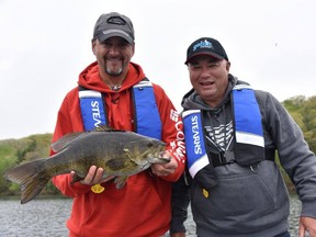 Columnist Frank Clark (left) holds up a 6.2-pound smallmouth caught on a lipless crankbait while filming with legend Bob Izumi. Photo supplied