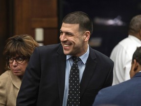 Former New England Patriots tight end Aaron Hernandez smiles at the sight of his fiancee Shayanna Jenkins Hernandez, who brought the couple's daughter to court, during jury deliberations in his double-murder trial at Suffolk Superior Court in Boston on April 12, 2017. (Keith Bedford/The Boston Globe via AP, Pool)