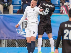 Jacksonville Armada's Jake Black heads the ball against FC Edmonton captain Nik Ledgerwood at Clarke Park in Edmonton on April 8, 2017. (Amber Bracken)