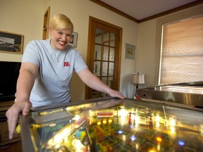 Julie Dorssers displays her talents Friday on one of  three pinball games at her London home.  She won her division at the Professional and Amateur Pinball Association championships held last weekend near Pittsburgh, Pa. (MIKE HENSEN, The London Free Press)