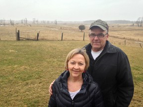 Amherst Island farmers Wayne and Karen Fleming are among those in favour of the wind energy project being built on the island. A wind turbine is to be built on their land behind them, as they stand in the front lawn of their house near Stella.