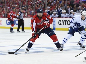 Washington Capitals right winger Justin Williams skates with the puck while pressured by Toronto Maple Leafs centre Auston Matthews during an NHL playoff game on April 13, 2017. The (AP Photo/Molly Riley)