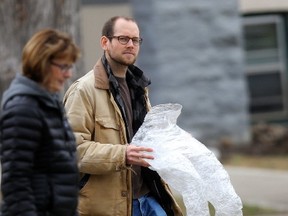 A man carries see through plastic legs during an event called Hunger Free Manitoba Stations of the Cross, in Winnipeg. Organized by Hunger Free Manitoba coalition and involving members of various faiths, the event marked the struggles of the homeless, and the hungry. Friday, April 14, 2017. CHRIS PROCAYLO/Winnipeg Sun/Postmedia Network