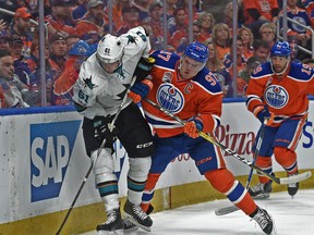 Connor McDavid (97)of the Edmonton Oilers hits Justin Braun of the San Jose Sharks at Rogers Place in Edmonton on April 14,  2017. Photo by Shaughn Butts / Postmedia