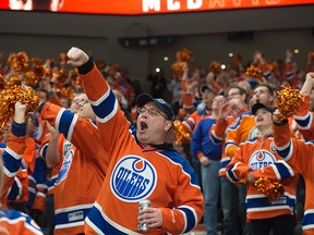 Fans of the Edmonton Oilers celebrate a third period goal against  San Jose Sharks in Game Two of the NHL first round playoffs at Rogers Place in Edmonton on April 14,  2017. Photo by Shaughn Butts / Postmedia